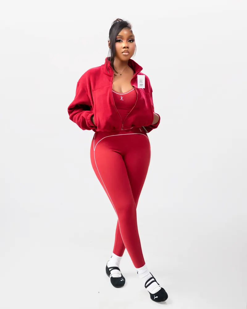 Red activewear set on white backdrop, visible clothing brand tag