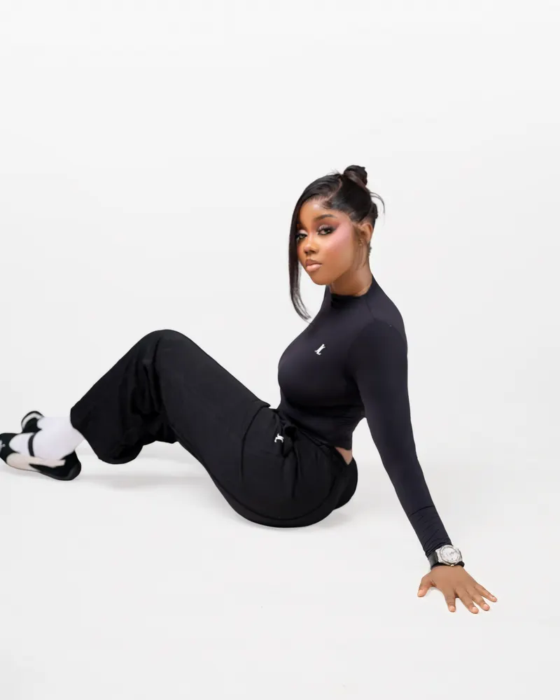 Black activewear, seated floor pose