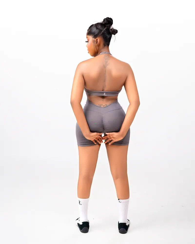 Grey activewear set, back view showing spine tattoo