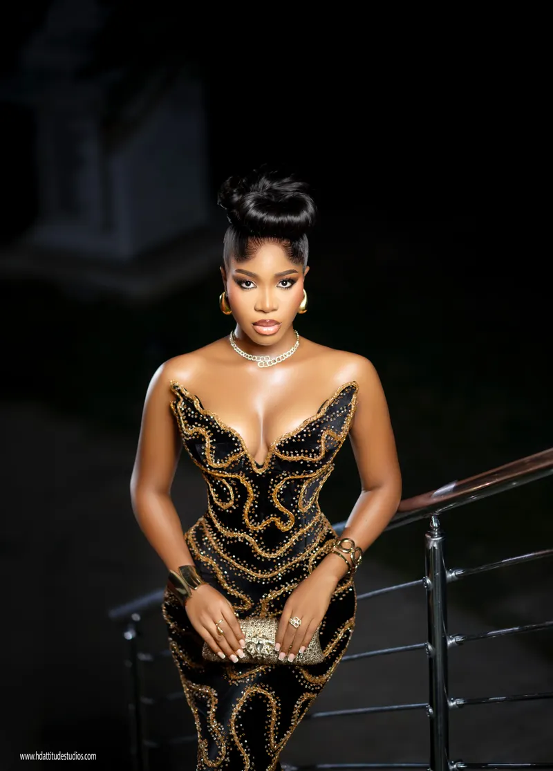 High-fashion black and gold beaded gown editorial with sculptural black headpiece