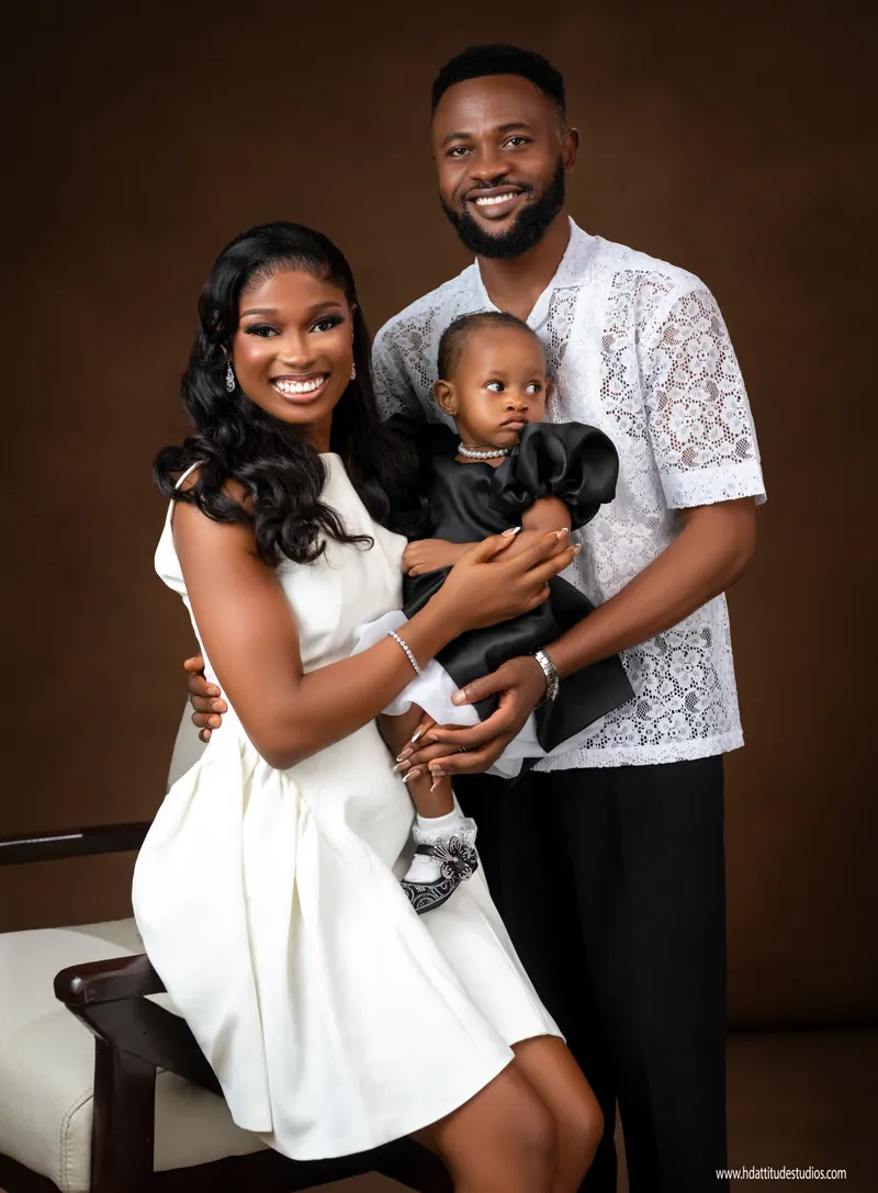 Same family, closer composition with toddler looking at camera