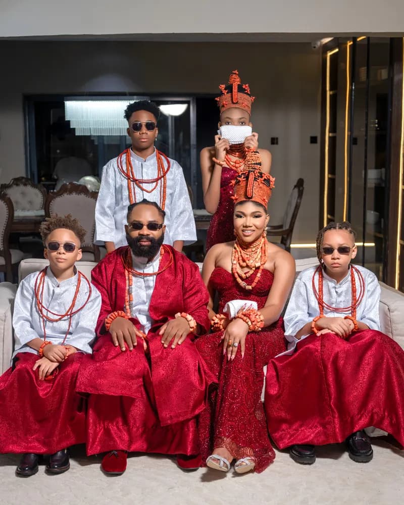 Family of six in red satin and coral beads, bride in elaborate coral coronet